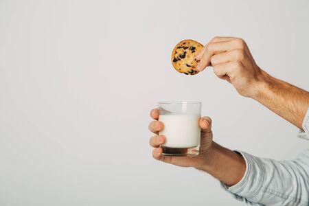 The guy is preparing a treat for Santa Claus. Snack for the new year. A glass of fresh natural milk with sweet biscuits without sugar and gluten.の写真素材