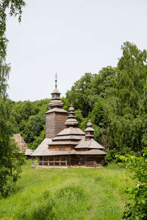 Old wooden church located in the forest on a glade. The church is made of woodの写真素材