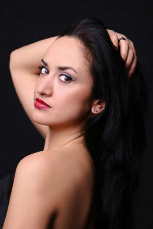 young girl looking at the camera. European-looking girl with black hair. shoulder baringの写真素材