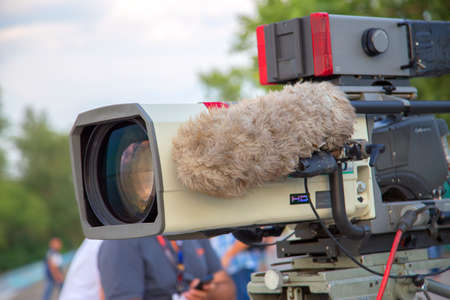 Professional video camera for recording sports programs. On the camera has a large microphoneの写真素材