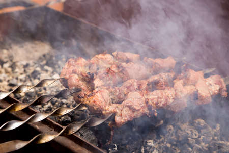 Barbecue on the grill. In the picture there are grill rotisserie smoke and embersの写真素材