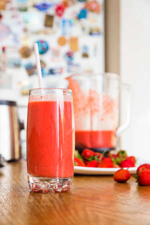 a glass of strawberry cocktail on the kitchen tableの写真素材