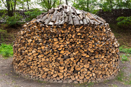 a heap of firewood stacked in the backyardの写真素材