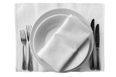 on a napkin, are two plates with knives and forks Isolation