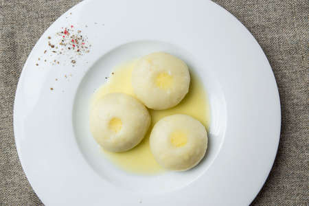 Three potato dumplings on a plateの写真素材