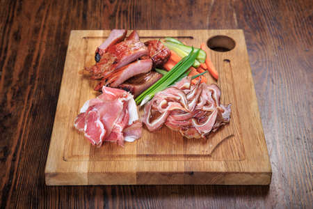 wooden board on the table with smoked beer snacks - ribs, pork ears, jamonの写真素材