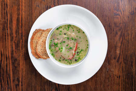 on the table a plate of soup, bread croutonsの写真素材