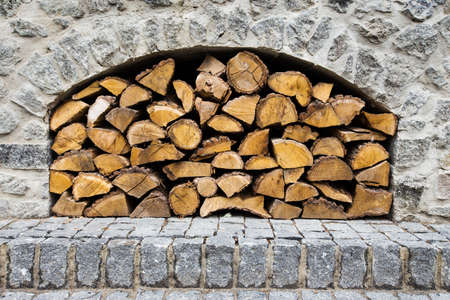 stone fireplace with firewood without fireの写真素材
