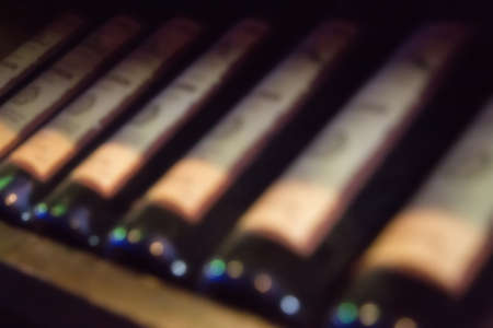 wine bottles lying in a row, blurred backgroundの写真素材