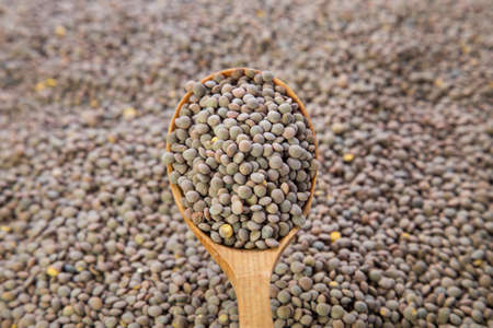 lentils vegetarian food. lentils in a wooden spoon. view from above. close up.の写真素材