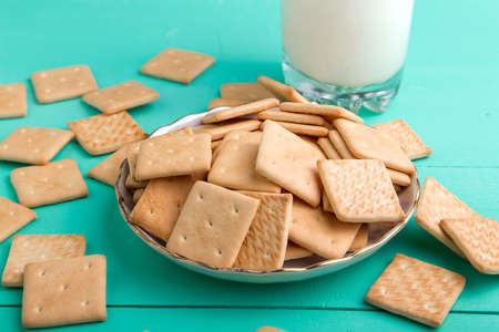 healthy breakfast glass of milk and crackers on a wooden blue surface on a linen napkin, top viewの写真素材