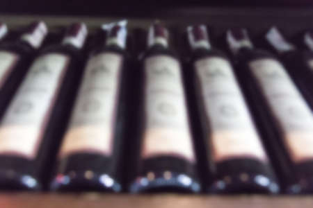 wine bottles lying in a row, blurred backgroundの写真素材