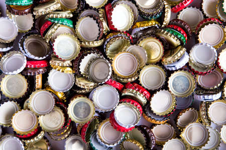 a lot of caps of beer, randomly scattered, background, top viewの写真素材