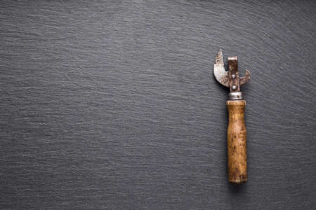 old rusty Soviet opener on slate blackboard, top viewの写真素材