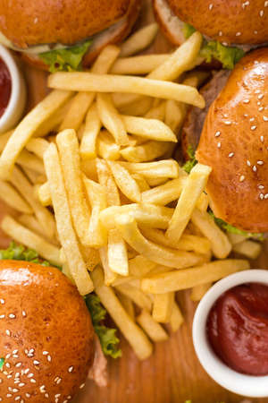 burgers with bacon, lettuce and sesame seeds, with french fries and ketchup sauceの写真素材