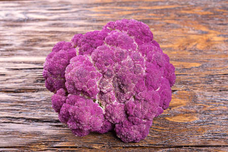 Purple cauliflower on a wooden board, diet, autumn harvestの写真素材