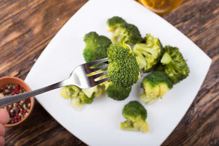 Boiled broccoli on a plate, One inflorescence cabbage on a fork,  healthy eating, diet Ducaneの写真素材
