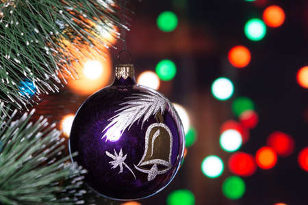 on bokeh background Christmas toy ball is hanging on a Christmas tree. space for text.の写真素材