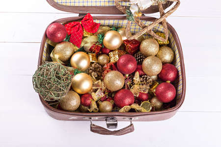 old suitcase that holds Christmas toys on a white background, the spirit of Christmasの写真素材