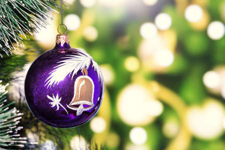 on bokeh background Christmas toy ball is hanging on a Christmas tree. space for text.の写真素材