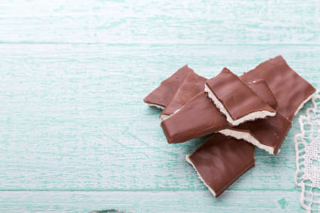 pieces of chocolate with white filling stacked tower on the wooden backgroundの写真素材