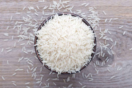 Japanese traditional food, uncooked rice in a bowl on a wooden backgroundの写真素材