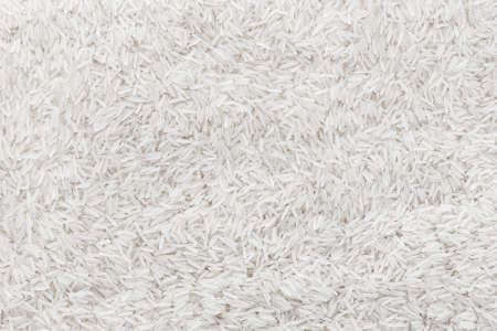 spilled crude basmati rice background, well some grain visibleの写真素材