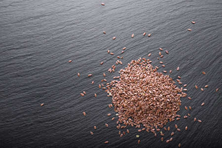a scattered fresh raw buckwheat on a black background, with space for textの写真素材