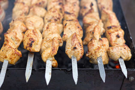 barbecue on the grill, meat threaded on skewers, summer picnic