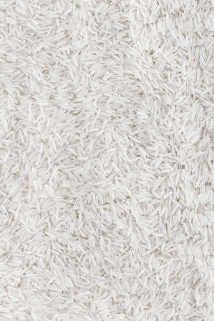 spilled crude basmati rice background, well some grain visibleの写真素材