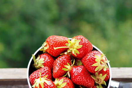 Fresh ripe red strawberries on wooden table in natural backgroundの写真素材