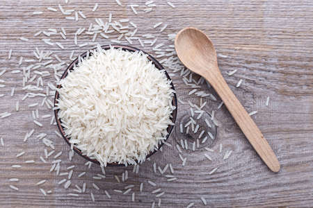 Japanese traditional food, uncooked rice in a bowl on a wooden backgroundの写真素材