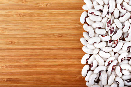 kidney beans is scattered on a wooden background, with space for textの写真素材