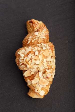 Traditional nourishing breakfast croissant on a black backgroundの写真素材