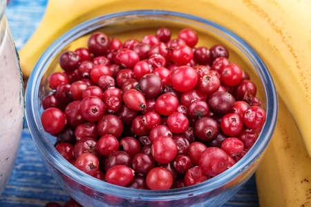 ripe cranberries in a glass dish on the tableの写真素材