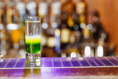 Cocktail shot green mexican with banana liqueur, lemon juice and tequila. Horizontal photoの写真素材