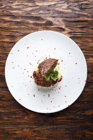 cutlets of elk with mashed potatoes with parsley on a plate with sauce on wooden background. horizontalの写真素材