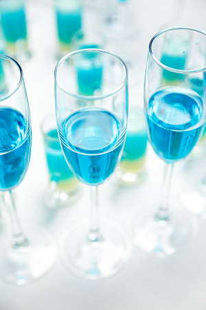 Unusual blue wine champagne in glasses in a restaurant or bar, romantic dinnerの写真素材