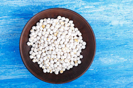 Vegetarian nutritious food, chickpeas in a clay plate on a wooden background, top view, horizontal photoの写真素材