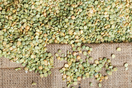 uncooked peas scattered on the sacking, a dietary nutritional productの写真素材