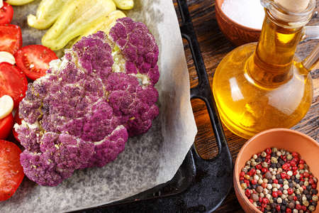 Different vegetables for baking on a baking sheet. Healthy organic food and spicesの写真素材