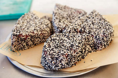 Cooked steaks of tuna in black and white sesame on a plateの写真素材