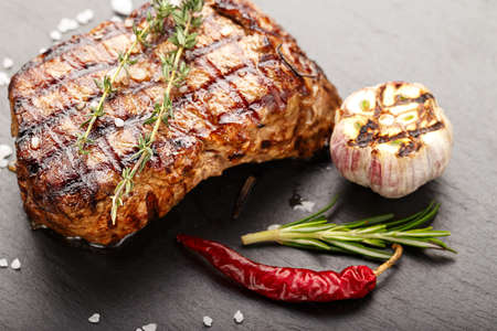 Cooked steak marble grilled meat with spices. Photo for menu, space for textの写真素材