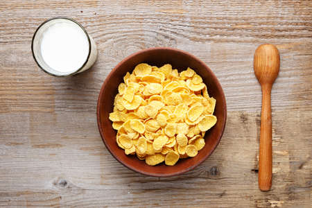Cornflakes cereal and milk in a clay bowl. Morning breakfast.