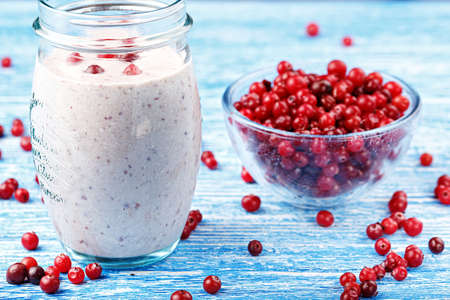 healthy nutritious breakfast with milk, cottage cheese, and cranberry - Cranberry smoothie in a glassの写真素材