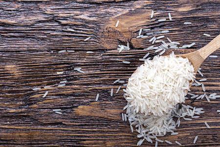 traditional food, uncooked rice in a bowl on a wooden backgroundの写真素材