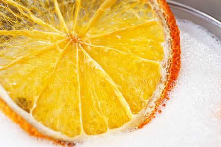 Cocktail background photo for the menu - a foamy cap on a cocktail, garnished with an orange slice, space for text.の写真素材