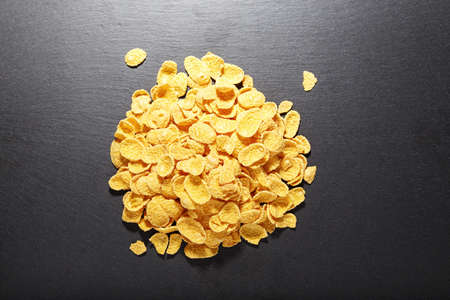 Corn flakes piled on a black backgroundの写真素材