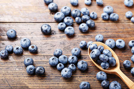 Blueberries scattered on a wooden background, rural appearance, organic menuの写真素材