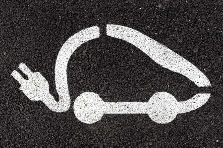 Electric vehicle charging sign applied to the asphalt with white paintの写真素材